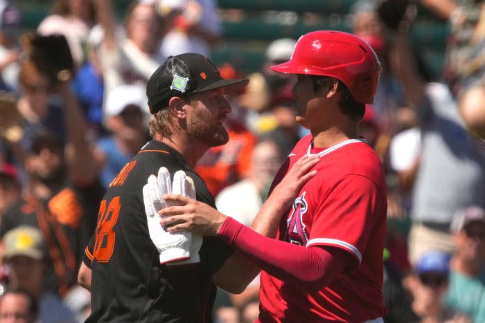 SF Giants starting pitcher Alex Cobb talks to Los Angeles Angels designated hitter Shohei Ohtani in between the innings during a spring training game at Tempe Diablo Stadium. (2022)